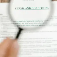 A magnifying glass over a Terms and Conditions document