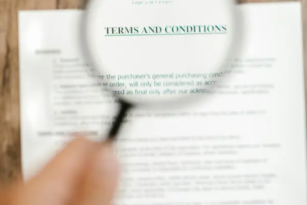 A magnifying glass over a Terms and Conditions document